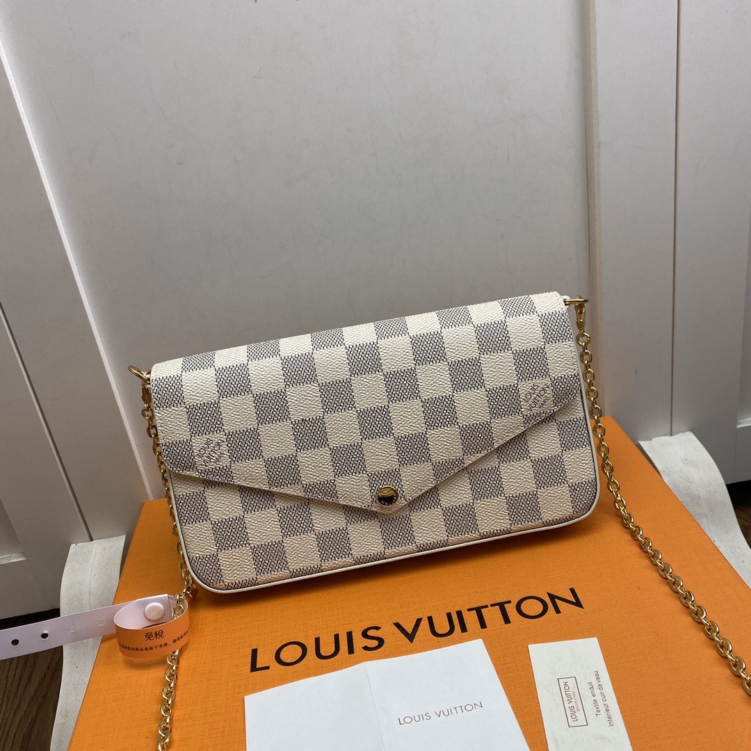 LOUIS VUITTON Pochette Félicie. Original quality bag including gift box, literature, dust bag, authenticity card. The Pochette Félicie in Monogram canvas is a stylish solution to carry and organize daily essentials. This versatile pouch features two removable pockets, including one with several card slots. It can be carried as a clutch or a shoulder bag thanks to a removable gold-tone chain. | Cris and Coco authentic quality designer bags and luxury accessories.