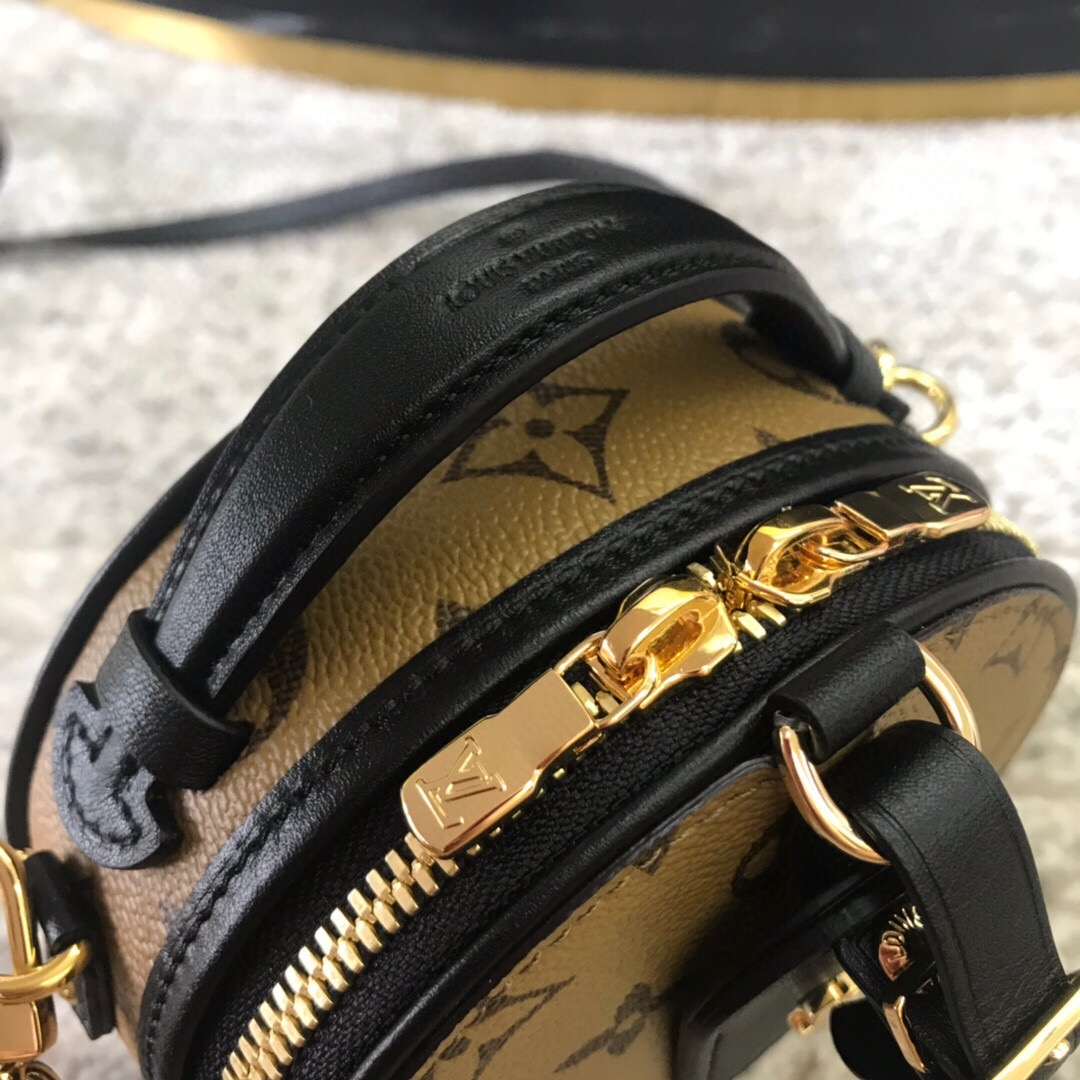 LOUIS VUITTON Petite Boite Chapeau. Original Quality Bag including gift box, literature, dust bag, authenticity card. Fashioned from Monogram Reverse canvas, the Mini Boîte Chapeau delights with its iconic shape and classic Louis Vuitton details such as the leather name tag and interior malletage quilting. The zip closure reveals a well-organized inside with two large gusseted compartments. It can be worn as a belt bag, carried by the handle, on the shoulder thanks to the removable strap.| Cris and Coco Authentic Quality Designer Bags and Luxury Accessories