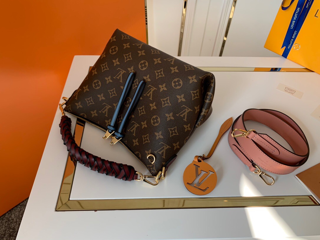 LOUIS VUITTON Beaubourg Hobo Mini Handbag. Authentic Quality Bag, including gift box, literature, dust bag, authenticity card. The adorable Beaubourg Hobo Mini handbag in Monogram canvas comes with a stylishly braided top handle. The House’s exceptional leather craftsmanship can be seen in the hand-painted edge dyeing on the braids. The oversized LV charm adds a sophisticated touch while the colorful name tag and shoulder strap bring a playful feel. This is an excellent handbag, ideal for day wear. | Cris and Coco Authentic Quality Designer Bags and Luxury Accessories