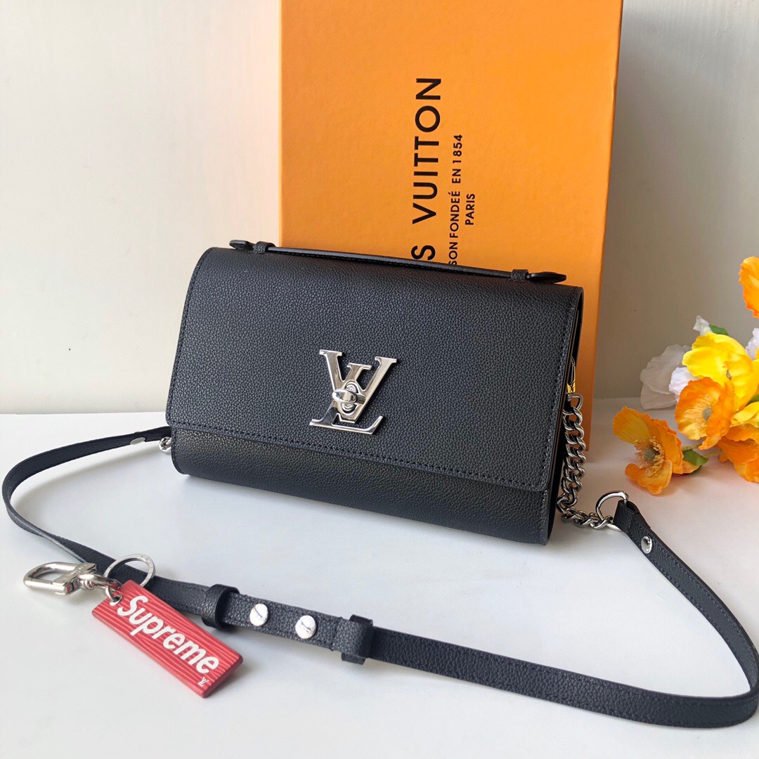 LOUIS VUITTON Lockme Clutch. Original Quality Bag including gift box, literature, dust bag, authenticity card. With its iconic LV turn lock and leather top handle for clutch carry, the Lockme Clutch is a striking day-to-evening bag. It boasts a clever strap with press studs to easily adjust the length for shoulder or cross-body carry. The small chain at the end of the strap brings a precious touch for evening occasions. | CRIS&COCO Authentic Quality Designer Bag and Luxury Accessories