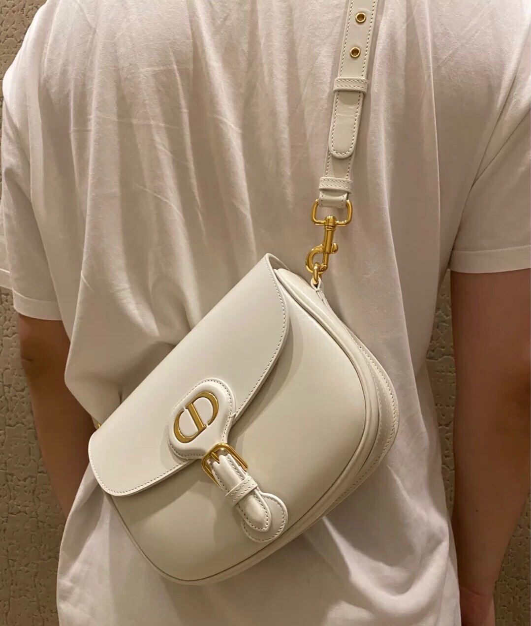 DIOR Small Bobby Bag. Original Quality Bag, including gift box, literature, dust bag, authenticity card. Maria Grazia Chiuri introduced a new silhouette to the French fashion house’s repertoire of It bags: the Dior Bobby which pays homage to the lovely pooch of the master himself. The Dior Bobby is a rounded flap that is similar to the D-fence bag with the classic CD logo. Got to admit, Bobby offers the best size for a bag that’s meant to be functional, easy to strut around in while looking like a million bucks. The Dior Bobby is a sassy shoulder bag that’s well suited for today’s call for practicality. Its feminine curve and the ‘30 Montaigne’ address on the back, renders a subtle echo of the eponymous symbolic bag. | crisandcoco designer bags and accessories