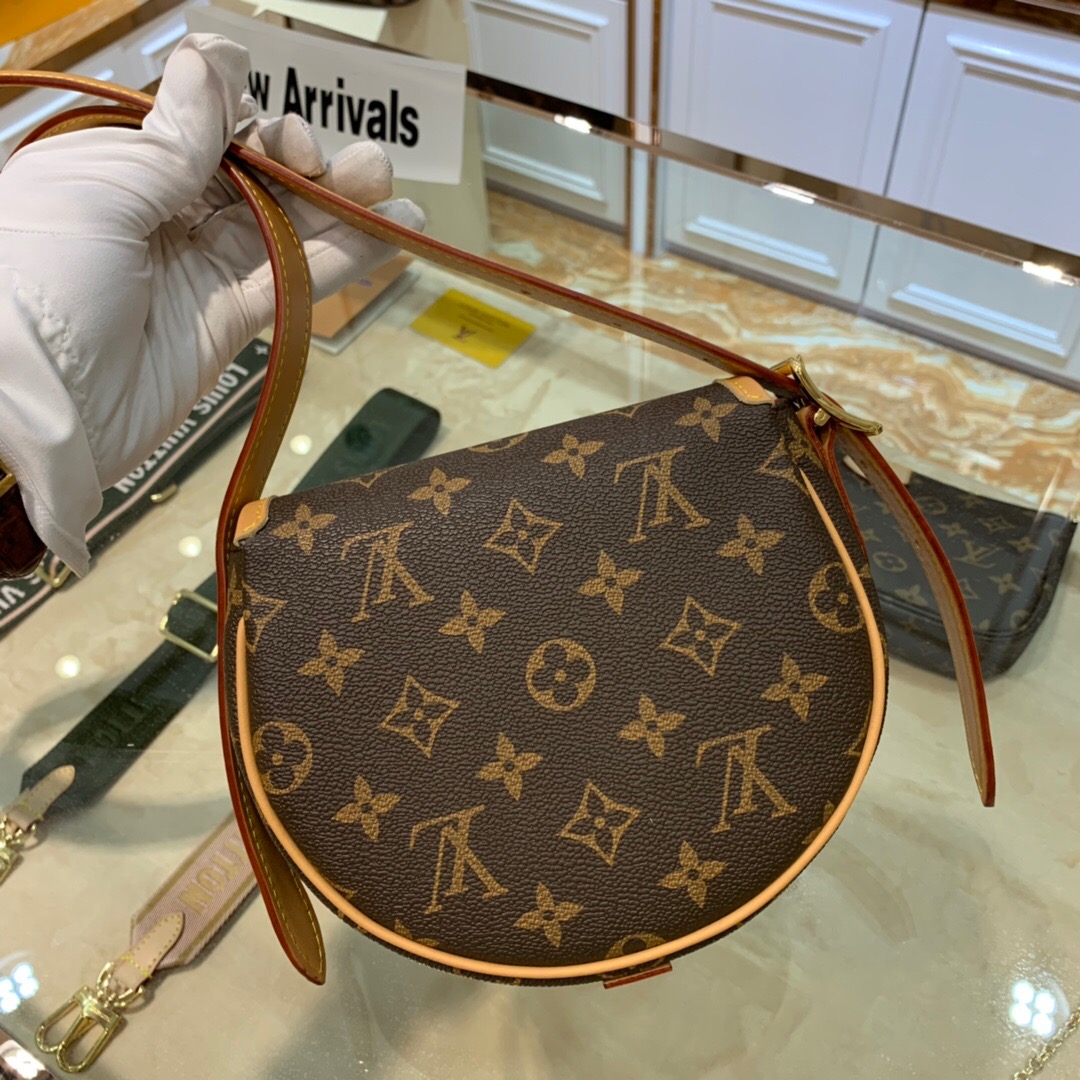 LOUIS VUITTON Tambourin Monogram Crossbody Bag. Original Quality Bag including gift box, care book, dust bag, authenticity card. Nicolas Ghesquière introduces a new version of the versatile and easy-to-wear LOUIS VUITTON Tambourin Monogram Crossbody Bag, made from Monogram canvas and natural cowhide leather. Small and lightweight with a practical inside pocket, this functional bag is ideal for everyday use. It can be worn over the shoulder or cross-body. | CRIS&COCO Authentic Quality Designer Bags and Luxury Accessories