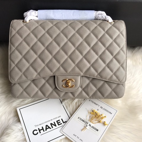 CHANEL Maxi Classic Handbag. Original Quality Bag including gift box, care book, dust bag, authenticity card. The Maxi Classic Double Flap bags are available in both grained calfskin and lambskin with silver/gold tone hardware. This classic handbag features a front flap with signature CC turn lock closure, half-moon back pocket. Also an adjustable interwoven silver/gold tone chain link and leather shoulder strap. | CRIS&COCO Authentic Quality Designer Bags and Luxury Accessories