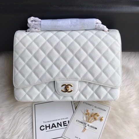CHANEL Maxi Classic Handbag. Original Quality Bag including gift box, care book, dust bag, authenticity card. The Maxi Classic Double Flap bags are available in both grained calfskin and lambskin with silver/gold tone hardware. This classic handbag features a front flap with signature CC turn lock closure, half-moon back pocket. Also an adjustable interwoven silver/gold tone chain link and leather shoulder strap. | CRIS&COCO Authentic Quality Designer Bags and Luxury Accessories