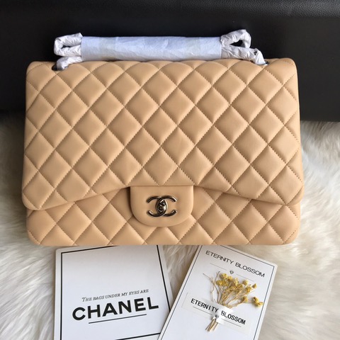 CHANEL Maxi Classic Handbag. Original Quality Bag including gift box, care book, dust bag, authenticity card. The Maxi Classic Double Flap bags are available in both grained calfskin and lambskin with silver/gold tone hardware. This classic handbag features a front flap with signature CC turn lock closure, half-moon back pocket. Also an adjustable interwoven silver/gold tone chain link and leather shoulder strap. | CRIS&COCO Authentic Quality Designer Bags and Luxury Accessories