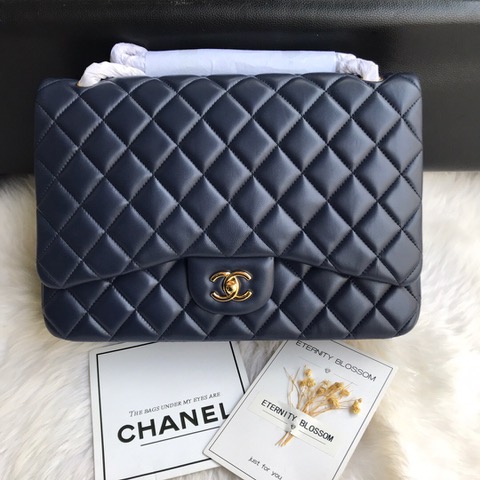 CHANEL Maxi Classic Handbag. Original Quality Bag including gift box, care book, dust bag, authenticity card. The Maxi Classic Double Flap bags are available in both grained calfskin and lambskin with silver/gold tone hardware. This classic handbag features a front flap with signature CC turn lock closure, half-moon back pocket. Also an adjustable interwoven silver/gold tone chain link and leather shoulder strap. | CRIS&COCO Authentic Quality Designer Bags and Luxury Accessories