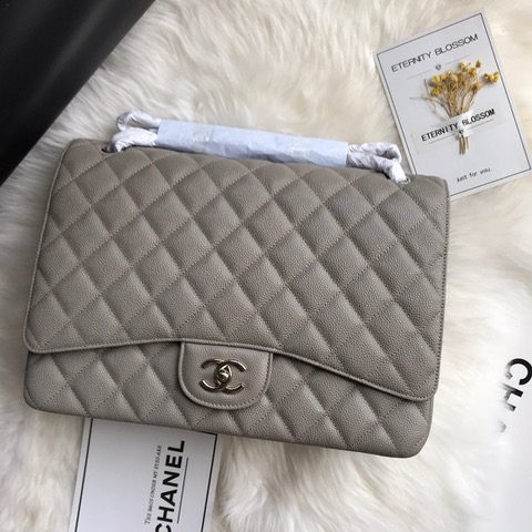 CHANEL Maxi Classic Handbag. Original Quality Bag including gift box, care book, dust bag, authenticity card. The Maxi Classic Double Flap bags are available in both grained calfskin and lambskin with silver/gold tone hardware. This classic handbag features a front flap with signature CC turn lock closure, half-moon back pocket. Also an adjustable interwoven silver/gold tone chain link and leather shoulder strap. | CRIS&COCO Authentic Quality Designer Bags and Luxury Accessories
