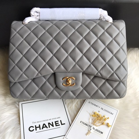 CHANEL Maxi Classic Handbag. Original Quality Bag including gift box, care book, dust bag, authenticity card. The Maxi Classic Double Flap bags are available in both grained calfskin and lambskin with silver/gold tone hardware. This classic handbag features a front flap with signature CC turn lock closure, half-moon back pocket. Also an adjustable interwoven silver/gold tone chain link and leather shoulder strap. | CRIS&COCO Authentic Quality Designer Bags and Luxury Accessories