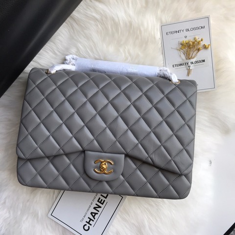 CHANEL Maxi Classic Handbag. Original Quality Bag including gift box, care book, dust bag, authenticity card. The Maxi Classic Double Flap bags are available in both grained calfskin and lambskin with silver/gold tone hardware. This classic handbag features a front flap with signature CC turn lock closure, half-moon back pocket. Also an adjustable interwoven silver/gold tone chain link and leather shoulder strap. | CRIS&COCO Authentic Quality Designer Bags and Luxury Accessories