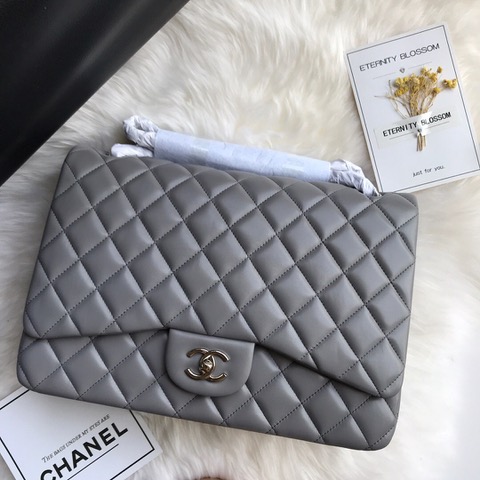 CHANEL Maxi Classic Handbag. Original Quality Bag including gift box, care book, dust bag, authenticity card. The Maxi Classic Double Flap bags are available in both grained calfskin and lambskin with silver/gold tone hardware. This classic handbag features a front flap with signature CC turn lock closure, half-moon back pocket. Also an adjustable interwoven silver/gold tone chain link and leather shoulder strap. | CRIS&COCO Authentic Quality Designer Bags and Luxury Accessories
