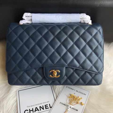 CHANEL Maxi Classic Handbag. Original Quality Bag including gift box, care book, dust bag, authenticity card. The Maxi Classic Double Flap bags are available in both grained calfskin and lambskin with silver/gold tone hardware. This classic handbag features a front flap with signature CC turn lock closure, half-moon back pocket. Also an adjustable interwoven silver/gold tone chain link and leather shoulder strap. | CRIS&COCO Authentic Quality Designer Bags and Luxury Accessories