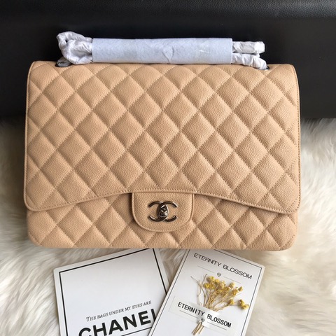 CHANEL Maxi Classic Handbag. Original Quality Bag including gift box, care book, dust bag, authenticity card. The Maxi Classic Double Flap bags are available in both grained calfskin and lambskin with silver/gold tone hardware. This classic handbag features a front flap with signature CC turn lock closure, half-moon back pocket. Also an adjustable interwoven silver/gold tone chain link and leather shoulder strap. | CRIS&COCO Authentic Quality Designer Bags and Luxury Accessories