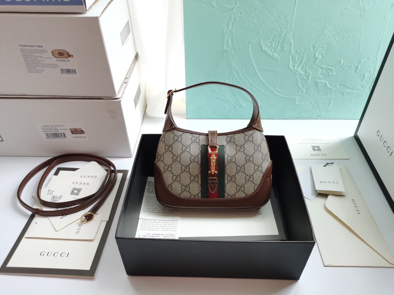 GUCCI Jackie 1961 Mini Hobo Bag. Original Quality Bag including gift box, care book, dust bag, authenticity card. The reintroduction of the Jackie bag in a mini size presents a new take on a historical Gucci icon. Brought back to the forefront, the recognizable shape is presented in leather and enhanced with an additional, detachable shoulder strap. Attached to the bag with a buckle closure, the second strap adds a contemporary feel to the archival style, providing new ways to wear—from top handle, shoulder to cross body. Pieces with versatile ways to wear and style embrace each person who is part of the House’s individual spirit. | CRIS&COCO Authentic Quality Designer Bags and Luxury Accessories