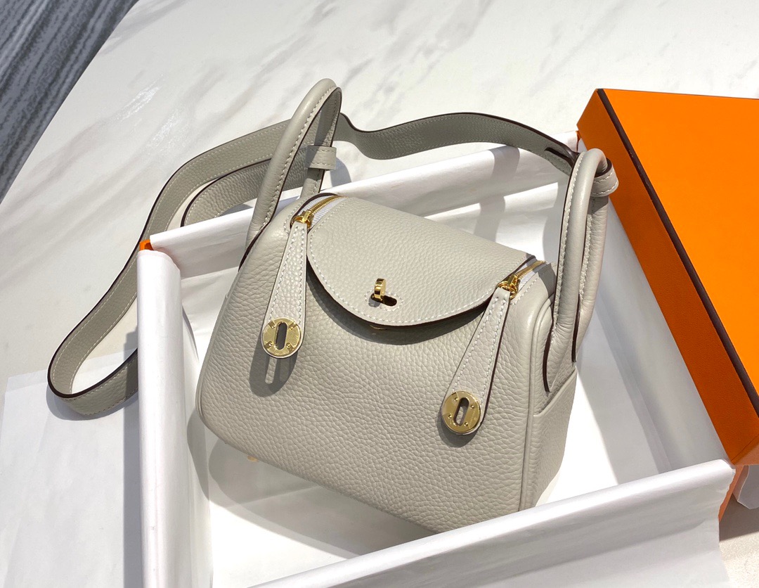 HERMÈS Mini Lindy. High-end quality bag including gift box, literature, dust bag, authenticity card. Maison HERMÈS is elevating the Lindy, with the introduction of the new Mini and is joining the holy Trinity, the Birkin, Kelly, and Constance.| CRIS AND COCO Authentic Quality Luxury Accessories