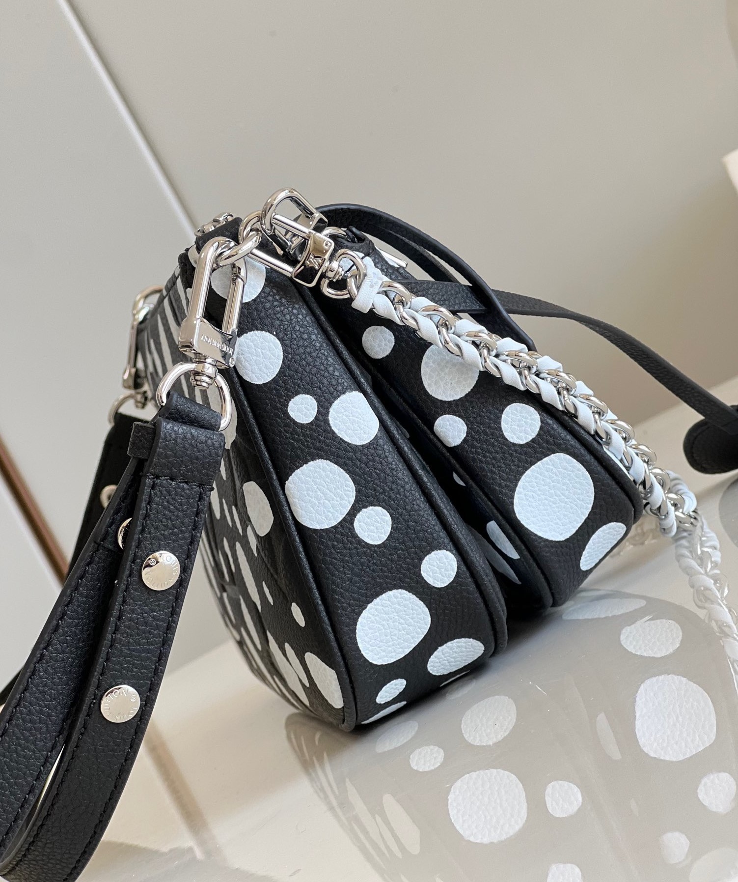 LOUIS VUITTON X Yayoi Kusama Multi Pochette Accessoires. Original Quality Bag including gift box, care book, dust bag, authenticity card. For the second Louis Vuitton x Yayoi Kusama collaboration, the 'Infinity Dots' design gives the LV x YK Multi Pochette Accessoires bag an upbeat new look. An array of different sized dots, a signature element in the revered Japanese artist’s work, is printed in white on fine cowhide leather embossed with the House’s emblematic Monogram pattern. For an extra flourish, another of Kusama’s favourite visual themes is echoed in the pumpkin-shaped charm. | CRIS&COCO Authentic Quality Designer Bag and Luxury Accessories