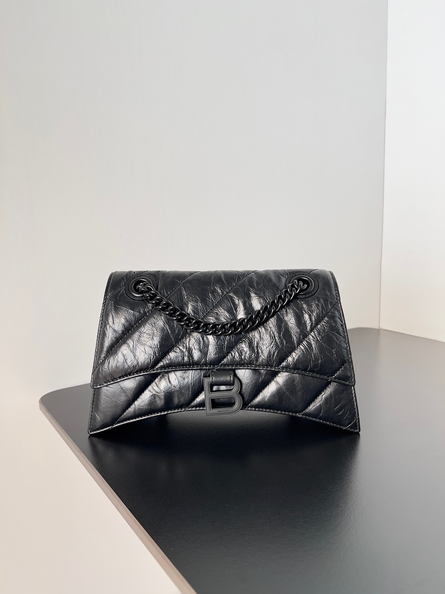 BALENCIAGA Crush Small Chain Bag. Original Quality Bag including gift box, care book, dust bag, authenticity card. Crush on this metallic Crush Chain Bag. This is a new iteration on their celebrated curvilinear design, complete with tonal B logo hardware and shoulder and crossbody chain. Crafted in a contemporary crushed quilted calfskin. | CRIS&COCO Authentic Quality Designer Bags and Luxury Accessories