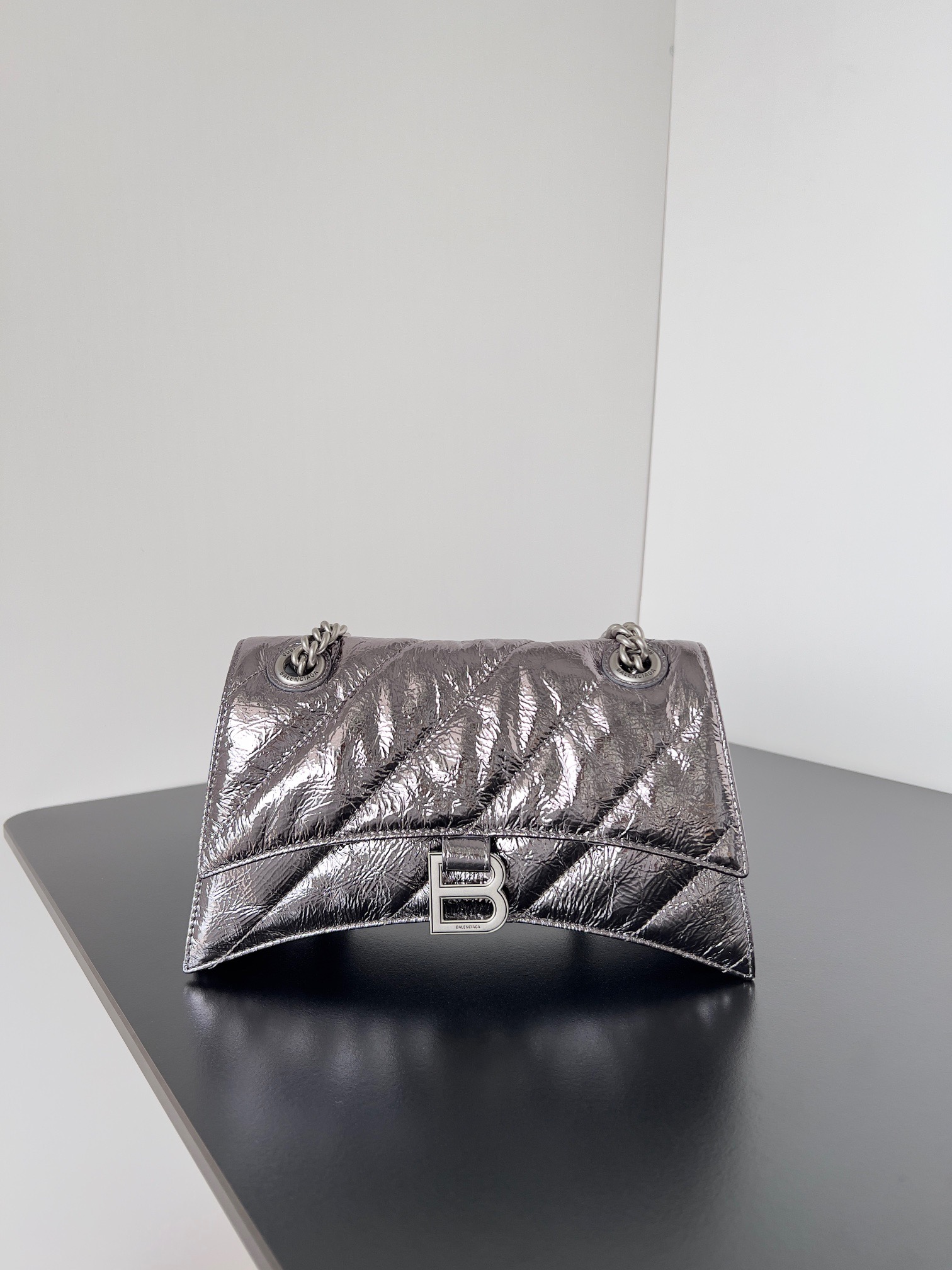 BALENCIAGA Crush Small Chain Bag. Original Quality Bag including gift box, care book, dust bag, authenticity card. Crush on this metallic Crush Chain Bag. This is a new iteration on their celebrated curvilinear design, complete with tonal B logo hardware and shoulder and crossbody chain. Crafted in a contemporary crushed quilted calfskin. | CRIS&COCO Authentic Quality Designer Bags and Luxury Accessories