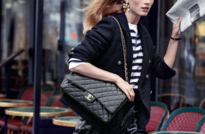 Timeless Elegance: The CHANEL Flap Bag in Action - CRIS&COCO A woman carrying a classic CHANEL Flap Bag, showcasing its iconic quilted leather and interlocking CC logo.