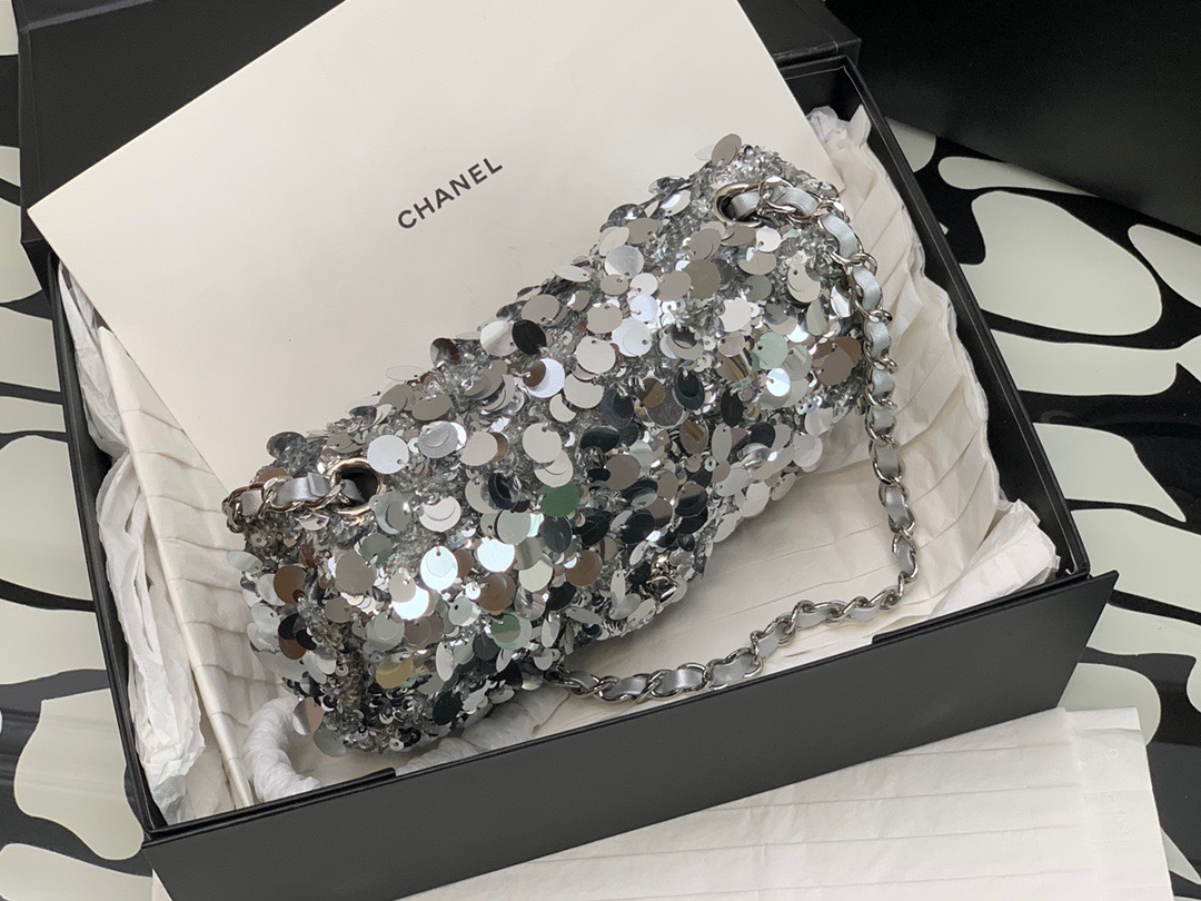 CHANEL Mini Flap Bag In Sequins.  Original Quality Bag including gift box, care book, dust bag, authenticity card. This small sleek flap bag is beautifully crafted of the layering of small and large sequins that create the entire surface of the bag. The elegant handbag features polished chain link leather threaded shoulder straps and a Chanel CC turn lock. This opens to a leather interior with room for your necessities for day or evening with the timeless style. | CRIS AND COCO Authentic Quality Luxury Accessories