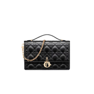 Miss-Dior-Top-Handle-Bag - CRIS&COCO Miss Dior Top Handle Bag– Your Day to Evening Essential. Elegance in Every Detail. Introducing the latest addition to the Cruise 2024 collection, the Miss Dior Top Handle bag embodies an exquisite blend of sophistication and functionality. Meticulously fashioned from luxurious black lambskin adorned with meticulous Cannage stitching, this bag showcases a gracefully adorned flap adorned by a captivating D.I.O.R. charm. Beneath this flap, you'll discover two spacious compartments and a secure zipped pouch, designed to effortlessly accommodate all your essentials, whether it's day or night. The signature Top Handle of this bag is both elegant and versatile, featuring a removable chain strap with a leather insert. This thoughtful design allows you to carry it comfortably in hand, wear it gracefully over your shoulder, or effortlessly sling it across your body for a stylish and adaptable look.