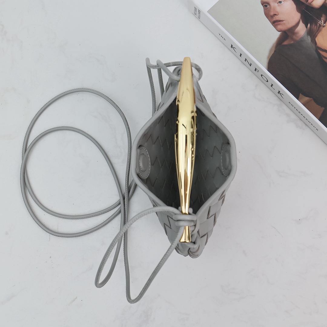 BOTTEGA VENETA Mini Sardine. Crafted to Perfection, Inspired by Nature: Your Timeless Companion for All Occasions. Bottega Veneta's masterful intrecciato weaving technique was originally crafted to ensure the enduring quality of leather goods. The Sardine Mini leather shoulder bag, meticulously fashioned from supple lamb leather, showcases a distinctive top handle reminiscent of a graceful fish. This versatile piece seamlessly transitions from day to night, making it the perfect, reliable companion to elegantly accommodate all your essentials.