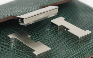Detailed close-up of the Hermès Constance iconic ‘H’ clasp.