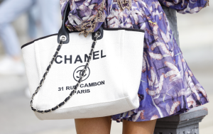 A chic CHANEL Deauville tote bag against the backdrop of the French Riviera.