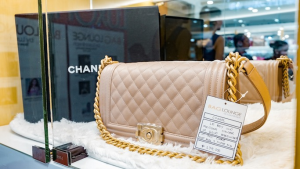 A luxury handbag displayed with a price tag in a high-end resale store
