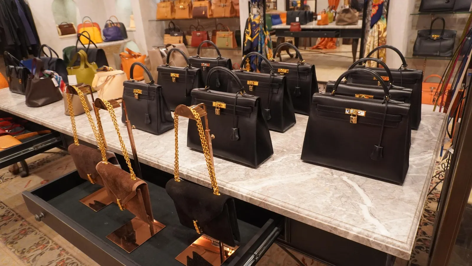 The Rise of Luxury Resale Rows of second-hand designer handbags, including LOUIS VUITTON and GUCCI, neatly displayed on shelves in a chic boutique.