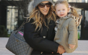 Stylish mom receiving a CHANEL-style handbag gift on Mother’s Day