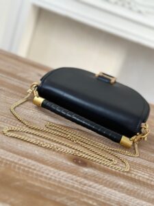 Marcie Chain Flap Bag. Authentic quality luxury bag crafted in genuine leather comes with authenticity card, dust bag and gift bag. Elevating Iconic Elegance: Marcie Line Redefined. Experience a fresh take on *loé's iconic Marcie line with this exquisite chain flap bag, meticulously crafted from a captivating blend of nappa lambskin, grained calfskin, and sumptuous suede. The line's signature hardware undergoes a graceful transformation, now adorned with *loé's engraved jewelry hallmark, adorning the flap with sophistication. An intricately hand-braided top handle pays homage to another hallmark Marcie feature, while a gracefully extended chain strap adds a refined touch. Whether you choose to drape it over your shoulder or wear it cross-body during the day, or opt to detach the strap and carry it by hand for a sophisticated evening ensemble, this flap bag is a versatile masterpiece. *loé's Marcie bag line effortlessly melds a feminine aesthetic with the free-spirited vibe of the '70s. An equestrian-inspired allure takes center stage, elevated by the allure of gleaming gold-toned hardware, resulting in a distinctly feminine yet timelessly chic look. - CRIS&COCO Marcie Chain Flap Bag. Authentic quality luxury bag crafted in genuine leather comes with authenticity card, dust bag and gift bag. Elevating Iconic Elegance: Marcie Line Redefined. Experience a fresh take on *loé's iconic Marcie line with this exquisite chain flap bag, meticulously crafted from a captivating blend of nappa lambskin, grained calfskin, and sumptuous suede. The line's signature hardware undergoes a graceful transformation, now adorned with *loé's engraved jewelry hallmark, adorning the flap with sophistication. An intricately hand-braided top handle pays homage to another hallmark Marcie feature, while a gracefully extended chain strap adds a refined touch. Whether you choose to drape it over your shoulder or wear it cross-body during the day, or opt to detach the strap and carry it by hand for a sophisticated evening ensemble, this flap bag is a versatile masterpiece. *loé's Marcie bag line effortlessly melds a feminine aesthetic with the free-spirited vibe of the '70s. An equestrian-inspired allure takes center stage, elevated by the allure of gleaming gold-toned hardware, resulting in a distinctly feminine yet timelessly chic look.