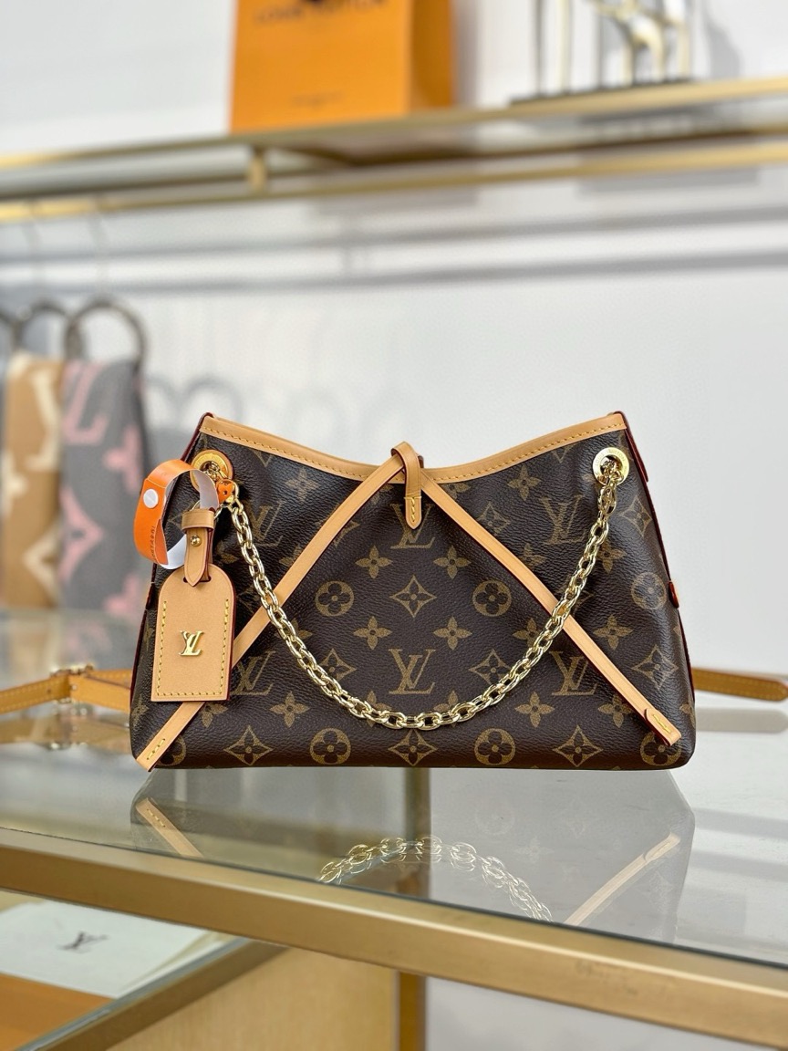 CarryAll BB. Authentic quality luxury bag crafted in genuine leather comes with authenticity card, dust bag and gift bag. Effortless Elegance, Day to Night – The CarryAll BB Reimagined. The iconic CarryAll BB returns this season with a stylish twist, perfect for transitioning from day to evening. Expertly crafted from the House’s signature Monogram canvas, it’s elevated with a gleaming gold-toned chain adorned with Monogram Flowers. Thoughtful details like the contrasting leather name tag and matching lace closure add a refined touch. Inside, a zipped pocket offers a convenient spot to keep your everyday essentials—like a credit card—close at hand.