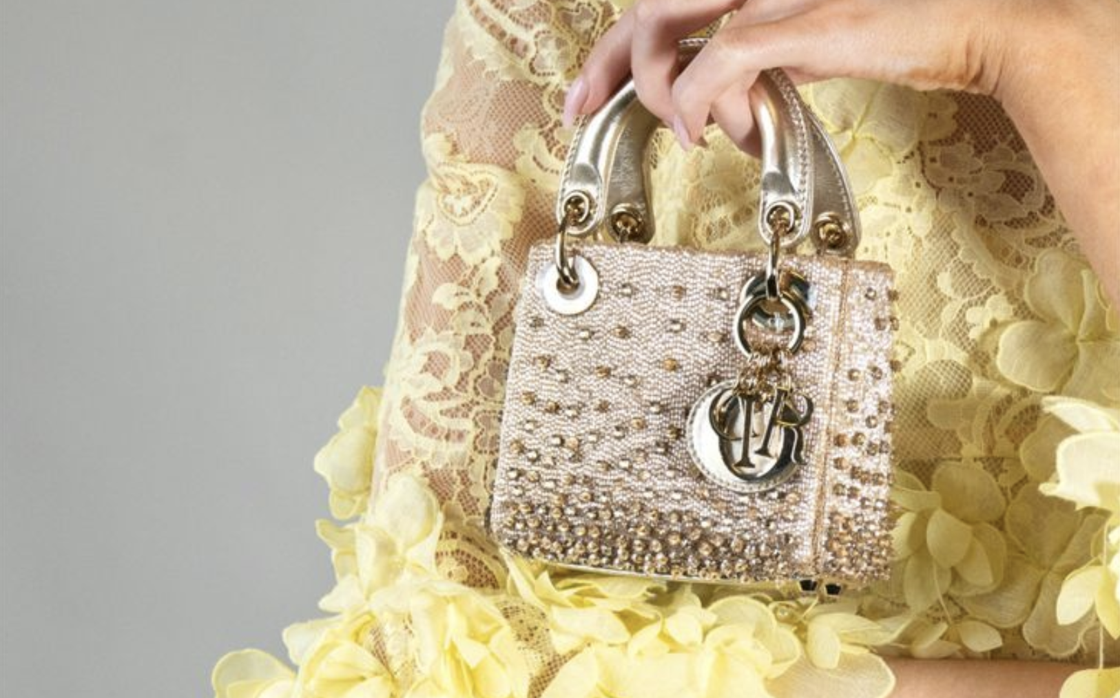 Gold clasp with engraved logo gleaming in soft light Gold clasp with engraved logo gleaming in soft light