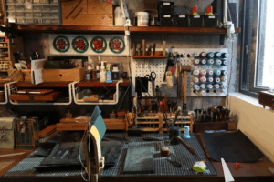 Interior of a high-end Chinese leather workshop with tools and half-finished bags