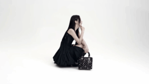 Stylish guest holding a bold mini bag