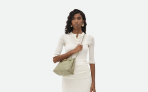 Mini designer handbag resting on a champagne table at a wedding reception