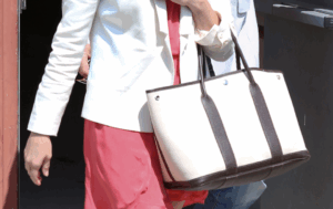 Graduate leaving campus with a HERMÈS Garden Party Tote