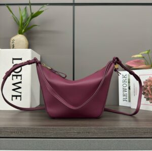 Mini Hammock Hobo. Authentic quality luxury bag crafted in genuine leather comes with authenticity card, dust bag and gift bag. Effortless Form, Everyday Function.  The Mini Hammock Hobo is a contemporary reimagining of Loewe’s iconic Hammock bag. This streamlined variation offers a sleek, sculptural silhouette designed as a versatile sling bag for modern living. Expertly crafted in classic calfskin, it features soft, supple leather and a compact form that adapts effortlessly to your day. The unique design allows for multiple carry options—wear it crossbody, over the shoulder, or by hand. Elegant yet functional, this mini hobo is perfect for essentials, making it an ideal choice for both daily wear and minimalist style statements.