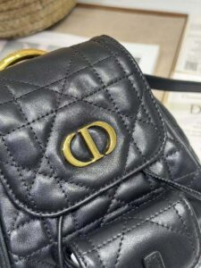 Small Caro Backpack. Authentic quality luxury bag crafted in genuine leather comes with authenticity card, dust bag and gift bag. Elegance Meets Effortless Edge. Elevate your everyday with the Small Caro Backpack — a flawless blend of modern femininity and iconic House craftsmanship. Luxuriously crafted in lambskin, its supple silhouette is enhanced by bold Macrocannage topstitching that whispers timeless *ior style. The antique gold-finish ‘CD’ clasp opens to a drawstring main compartment, perfectly balancing beauty and practicality. A discreet flap pocket keeps your daily essentials close at hand, while the top handle and adjustable leather straps offer versatile, all-day comfort. Whether slung over your shoulder or carried by hand, this petite powerhouse delivers Parisian polish in every step. - CRIS&COCO Small Caro Backpack. Authentic quality luxury bag crafted in genuine leather comes with authenticity card, dust bag and gift bag. Elegance Meets Effortless Edge. Elevate your everyday with the Small Caro Backpack — a flawless blend of modern femininity and iconic House craftsmanship. Luxuriously crafted in lambskin, its supple silhouette is enhanced by bold Macrocannage topstitching that whispers timeless *ior style. The antique gold-finish ‘CD’ clasp opens to a drawstring main compartment, perfectly balancing beauty and practicality. A discreet flap pocket keeps your daily essentials close at hand, while the top handle and adjustable leather straps offer versatile, all-day comfort. Whether slung over your shoulder or carried by hand, this petite powerhouse delivers Parisian polish in every step.