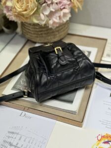 Small Caro Backpack. Authentic quality luxury bag crafted in genuine leather comes with authenticity card, dust bag and gift bag. Elegance Meets Effortless Edge. Elevate your everyday with the Small Caro Backpack — a flawless blend of modern femininity and iconic House craftsmanship. Luxuriously crafted in lambskin, its supple silhouette is enhanced by bold Macrocannage topstitching that whispers timeless *ior style. The antique gold-finish ‘CD’ clasp opens to a drawstring main compartment, perfectly balancing beauty and practicality. A discreet flap pocket keeps your daily essentials close at hand, while the top handle and adjustable leather straps offer versatile, all-day comfort. Whether slung over your shoulder or carried by hand, this petite powerhouse delivers Parisian polish in every step. - CRIS&COCO Small Caro Backpack. Authentic quality luxury bag crafted in genuine leather comes with authenticity card, dust bag and gift bag. Elegance Meets Effortless Edge. Elevate your everyday with the Small Caro Backpack — a flawless blend of modern femininity and iconic House craftsmanship. Luxuriously crafted in lambskin, its supple silhouette is enhanced by bold Macrocannage topstitching that whispers timeless *ior style. The antique gold-finish ‘CD’ clasp opens to a drawstring main compartment, perfectly balancing beauty and practicality. A discreet flap pocket keeps your daily essentials close at hand, while the top handle and adjustable leather straps offer versatile, all-day comfort. Whether slung over your shoulder or carried by hand, this petite powerhouse delivers Parisian polish in every step.