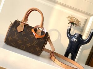 Speedy Nano. Authentic quality luxury bag crafted in genuine leather comes with authenticity card, dust bag and gift bag. Iconic Style, Perfectly Miniaturized. Meet the LV Speedy Nano — a petite powerhouse that captures the timeless allure of the iconic Speedy in its most charming form. Revamped in classic Monogram canvas and finished with aged natural cowhide leather, this mini marvel is made for the modern minimalist. Crafted with delicate gold-tone hardware and featuring two signature top handles, the Speedy Nano is both playful and practical. Its removable, adjustable shoulder strap adds effortless versatility—carry it by hand for polished poise or sling it crossbody for chic, on-the-go ease. Compact enough for your essentials. Iconic enough to turn heads. Small bag, big legacy! - CRIS&COCO Speedy Nano. Authentic quality luxury bag crafted in genuine leather comes with authenticity card, dust bag and gift bag. Iconic Style, Perfectly Miniaturized. Meet the LV Speedy Nano — a petite powerhouse that captures the timeless allure of the iconic Speedy in its most charming form. Revamped in classic Monogram canvas and finished with aged natural cowhide leather, this mini marvel is made for the modern minimalist. Crafted with delicate gold-tone hardware and featuring two signature top handles, the Speedy Nano is both playful and practical. Its removable, adjustable shoulder strap adds effortless versatility—carry it by hand for polished poise or sling it crossbody for chic, on-the-go ease. Compact enough for your essentials. Iconic enough to turn heads. Small bag, big legacy!