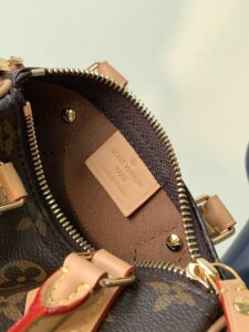 Speedy Nano. Authentic quality luxury bag crafted in genuine leather comes with authenticity card, dust bag and gift bag. Iconic Style, Perfectly Miniaturized. Meet the LV Speedy Nano — a petite powerhouse that captures the timeless allure of the iconic Speedy in its most charming form. Revamped in classic Monogram canvas and finished with aged natural cowhide leather, this mini marvel is made for the modern minimalist. Crafted with delicate gold-tone hardware and featuring two signature top handles, the Speedy Nano is both playful and practical. Its removable, adjustable shoulder strap adds effortless versatility—carry it by hand for polished poise or sling it crossbody for chic, on-the-go ease. Compact enough for your essentials. Iconic enough to turn heads. Small bag, big legacy!