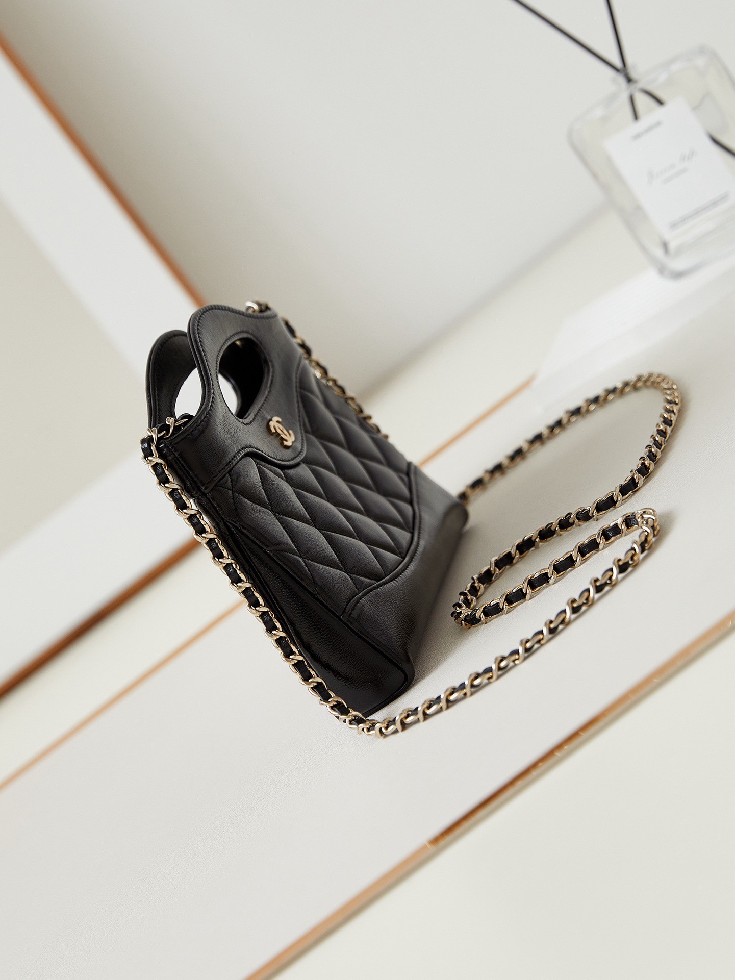 31 Nano Shopping Bag. Authentic quality luxury bag crafted in genuine leather comes with authenticity card, dust bag and gift bag. Small in size, grand in statement.  A miniature marvel that captures the sophistication of *ANEL in its most playful form. Crafted with meticulous precision, this petite icon merges the timeless spirit of the *ANEL 31 with a modern twist on everyday elegance. Designed in supple lambskin and finished with gleaming gold-tone hardware, the Nano 31 doesn’t just carry your essentials — it carries your attitude. Whether worn crossbody, by hand, or dangling from the crook of your arm, this charming piece elevates every ensemble with a whisper of Parisian chic. Perfect for a night out or a day in the spotlight, it’s not just a bag — it’s your boldest accessory in its most compact form. Because luxury doesn't need to shout. Sometimes, it just needs to charm.