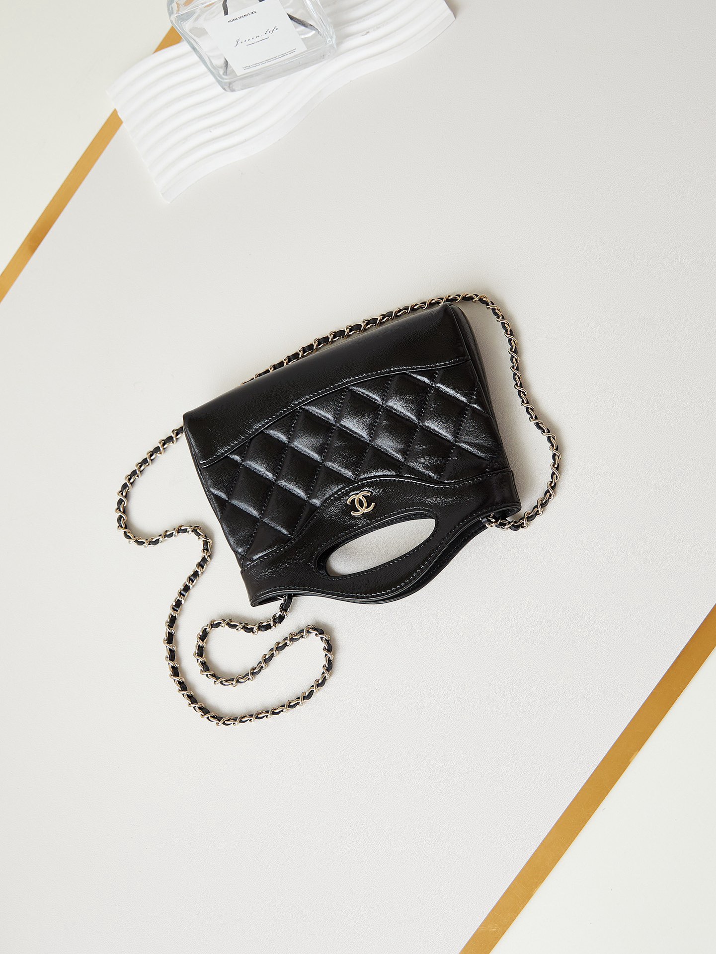 31 Nano Shopping Bag. Authentic quality luxury bag crafted in genuine leather comes with authenticity card, dust bag and gift bag. Small in size, grand in statement.  A miniature marvel that captures the sophistication of *ANEL in its most playful form. Crafted with meticulous precision, this petite icon merges the timeless spirit of the *ANEL 31 with a modern twist on everyday elegance. Designed in supple lambskin and finished with gleaming gold-tone hardware, the Nano 31 doesn’t just carry your essentials — it carries your attitude. Whether worn crossbody, by hand, or dangling from the crook of your arm, this charming piece elevates every ensemble with a whisper of Parisian chic. Perfect for a night out or a day in the spotlight, it’s not just a bag — it’s your boldest accessory in its most compact form. Because luxury doesn't need to shout. Sometimes, it just needs to charm.