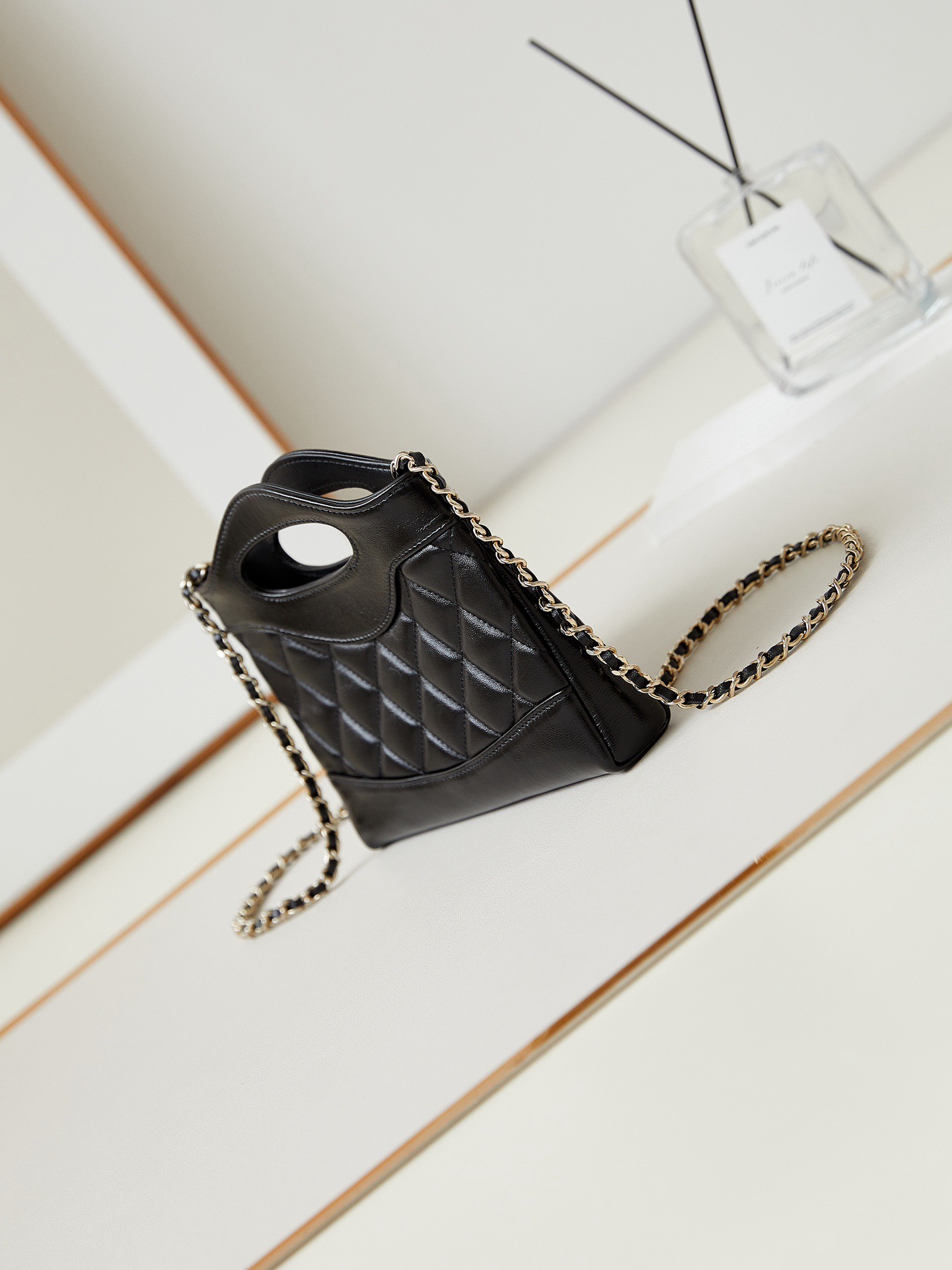 31 Nano Shopping Bag. Authentic quality luxury bag crafted in genuine leather comes with authenticity card, dust bag and gift bag. Small in size, grand in statement.  A miniature marvel that captures the sophistication of *ANEL in its most playful form. Crafted with meticulous precision, this petite icon merges the timeless spirit of the *ANEL 31 with a modern twist on everyday elegance. Designed in supple lambskin and finished with gleaming gold-tone hardware, the Nano 31 doesn’t just carry your essentials — it carries your attitude. Whether worn crossbody, by hand, or dangling from the crook of your arm, this charming piece elevates every ensemble with a whisper of Parisian chic. Perfect for a night out or a day in the spotlight, it’s not just a bag — it’s your boldest accessory in its most compact form. Because luxury doesn't need to shout. Sometimes, it just needs to charm.