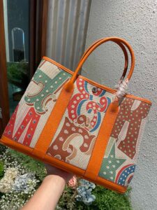 Garden Party Voyage. Authentic quality luxury bag crafted in genuine leather comes with authenticity card, dust bag and gift bag. The Art of Everyday Escape. Chic, structured, and effortlessly refined, the *RMÈS Garden Party Voyage is the perfect companion for your daily adventures or spontaneous weekend getaways. Crafted with precision in supple Negonda leather or canvas with leather trim, this midsize tote strikes the perfect balance between luxury and functionality. Its minimalist silhouette is elevated by discreet Clou de Selle snap closures and expandable sides, offering both form and flexibility. Spacious enough for your essentials yet compact enough to carry with ease, it’s a timeless piece designed to move with you—gracefully. Whether carried in hand or worn over the shoulder, the Garden Party Voyage 36 speaks in whispers of elegance and unmistakable *RMÈS craftsmanship. Every day is a journey. Travel beautifully. - CRIS&COCO Garden Party Voyage. Authentic quality luxury bag crafted in genuine leather comes with authenticity card, dust bag and gift bag. The Art of Everyday Escape. Chic, structured, and effortlessly refined, the *RMÈS Garden Party Voyage is the perfect companion for your daily adventures or spontaneous weekend getaways. Crafted with precision in supple Negonda leather or canvas with leather trim, this midsize tote strikes the perfect balance between luxury and functionality. Its minimalist silhouette is elevated by discreet Clou de Selle snap closures and expandable sides, offering both form and flexibility. Spacious enough for your essentials yet compact enough to carry with ease, it’s a timeless piece designed to move with you—gracefully. Whether carried in hand or worn over the shoulder, the Garden Party Voyage 36 speaks in whispers of elegance and unmistakable *RMÈS craftsmanship. Every day is a journey. Travel beautifully.