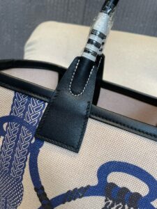 Steeple 25 Bag. Authentic quality luxury bag crafted in genuine leather comes with authenticity card, dust bag and gift bag. Where art meets heritage. The *rmès Steeple Bag is a charming fusion of heritage and artistry, crafted from a blend of canvas and Swift leather. Its design pays tribute to *rmès’ equestrian roots with whip-shaped handles and a stirrup-inspired charm, adding a playful yet sophisticated touch. Lightweight yet spacious, the Steeple is ideal for daily use. Whether you opt for a vibrant motif or a sleek, single-color design, this bag stands out as an artistic expression of luxury that seamlessly integrates into a modern lifestyle. Praised for its unique aesthetic and accessibility within the *rmès lineup, the Steeple Bag is adored by fashion enthusiasts who appreciate its colorful palette and bold personality. While it’s best suited for those who enjoy the texture and look of canvas, it remains a versatile statement piece that captures the spirit of everyday elegance.