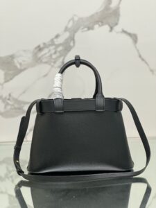 Buckle Small Leather Handbag. Authentic quality luxury bag crafted in genuine leather comes with authenticity card, dust bag and gift bag. Sophistication Meets Utility. Sleek, structured, and undeniably Pr*da — the Buckle Small Leather Handbag captures the brand’s signature balance of minimalist elegance and refined detail. Crafted in smooth leather with a buttery-soft nappa interior, this compact piece is a masterclass in functional luxury. A standout feature? Its interchangeable belt strap, adding a bold, modern twist to the timeless silhouette. Whether you're heading to a meeting or a soirée, this bag adapts seamlessly to your mood and moment. Finished with the embossed iconic logo, it’s a quiet statement of taste and distinction. A versatile companion for the woman who appreciates precision, polish, and just the right touch of edge. - CRIS&COCO Buckle Small Leather Handbag. Authentic quality luxury bag crafted in genuine leather comes with authenticity card, dust bag and gift bag. Sophistication Meets Utility. Sleek, structured, and undeniably Pr*da — the Buckle Small Leather Handbag captures the brand’s signature balance of minimalist elegance and refined detail. Crafted in smooth leather with a buttery-soft nappa interior, this compact piece is a masterclass in functional luxury. A standout feature? Its interchangeable belt strap, adding a bold, modern twist to the timeless silhouette. Whether you're heading to a meeting or a soirée, this bag adapts seamlessly to your mood and moment. Finished with the embossed iconic logo, it’s a quiet statement of taste and distinction. A versatile companion for the woman who appreciates precision, polish, and just the right touch of edge.