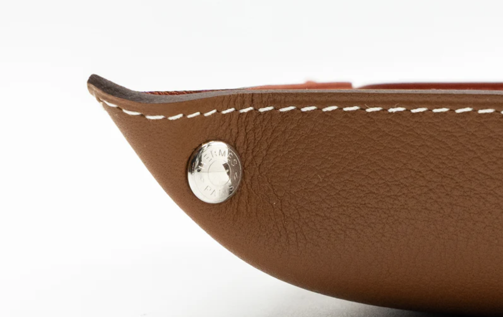 Hands arranging coins and keys on a replica change tray Hands arranging coins and keys on a replica change tray