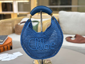 Summer Banana Hobo. Authentic quality luxury bag crafted in genuine leather comes with authenticity card, dust bag and gift bag. Artisanal Spirit, Curved in Style. Say hello to sunshine in bag form. The *LOÉ Summer Banana Hobo Bag is a joyful blend of craftsmanship and creativity, handwoven over four days by a single artisan in collaboration with Made For A Woman. This is not just a bag—it’s a story stitched in raffia and trimmed in luxurious calfskin. Its curved, banana-inspired silhouette hugs the shoulder with ease, while the sculptural handle and handwritten signature nod to *loé’s heritage of effortless elegance. Light, natural, and undeniably chic, it's the perfect companion for sun-soaked escapes or city strolls with a coastal state of mind. A celebration of craftsmanship, femininity, and the art of slow fashion.